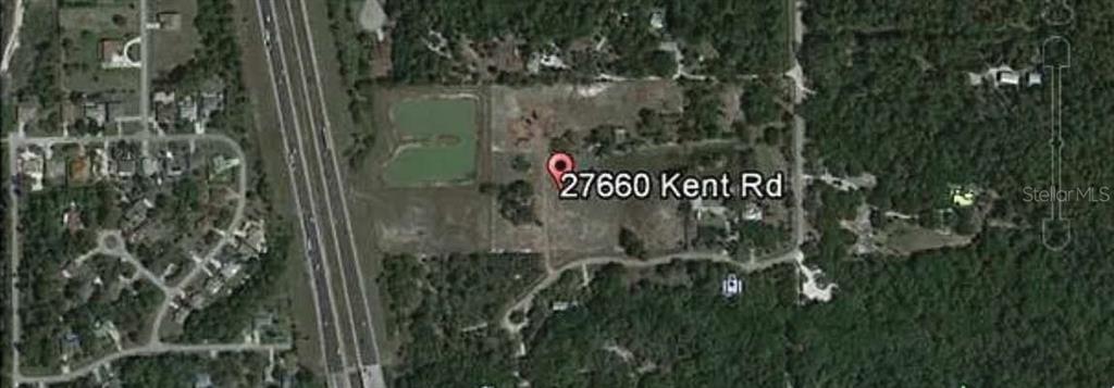 This is an aerial map view showing a plot of land with a pond — 27660 KENT ROAD, BONITA SPRINGS, FL