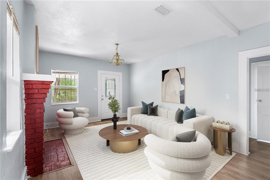 A living room features a red brick fireplace, white sofa, two rounded chairs, and wood flooring — 811 W AMELIA AVENUE, TAMPA, FL