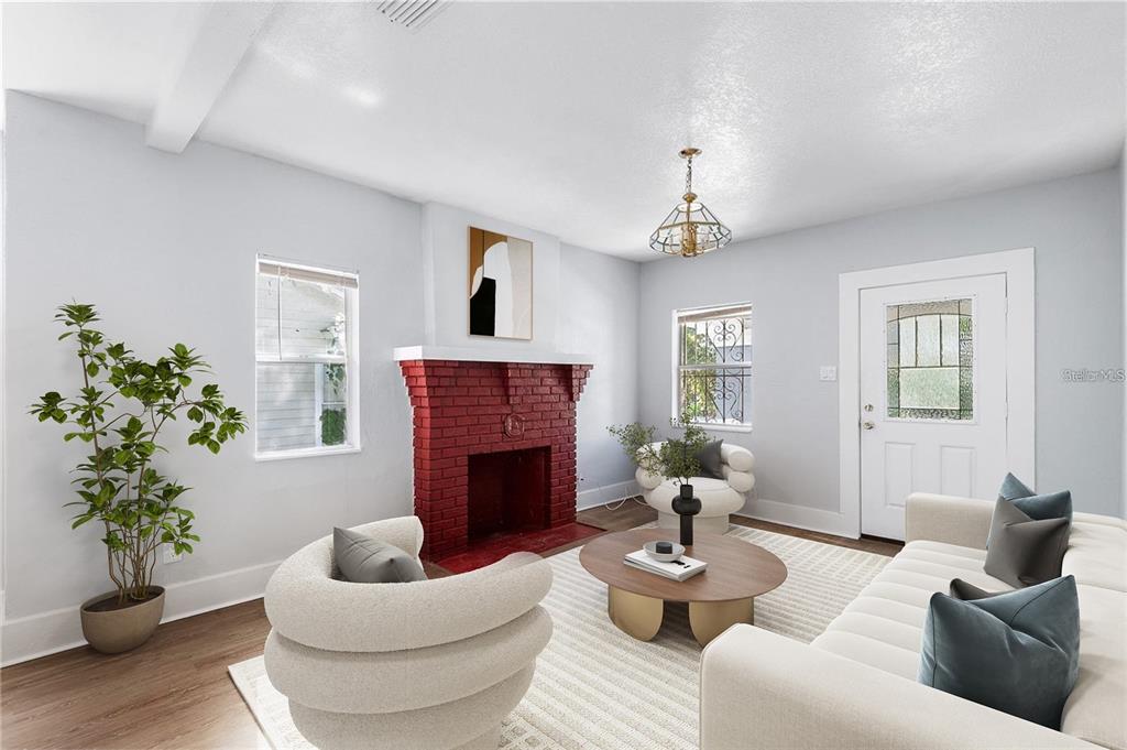 A living room features a red brick fireplace, white walls, and modern furniture — 811 W AMELIA AVENUE, TAMPA, FL