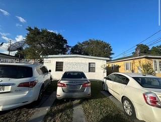 A single-story house exterior with three cars parked in the front yard — 1785 NW 56th St, Miami FL 33142, MIAMI, FL