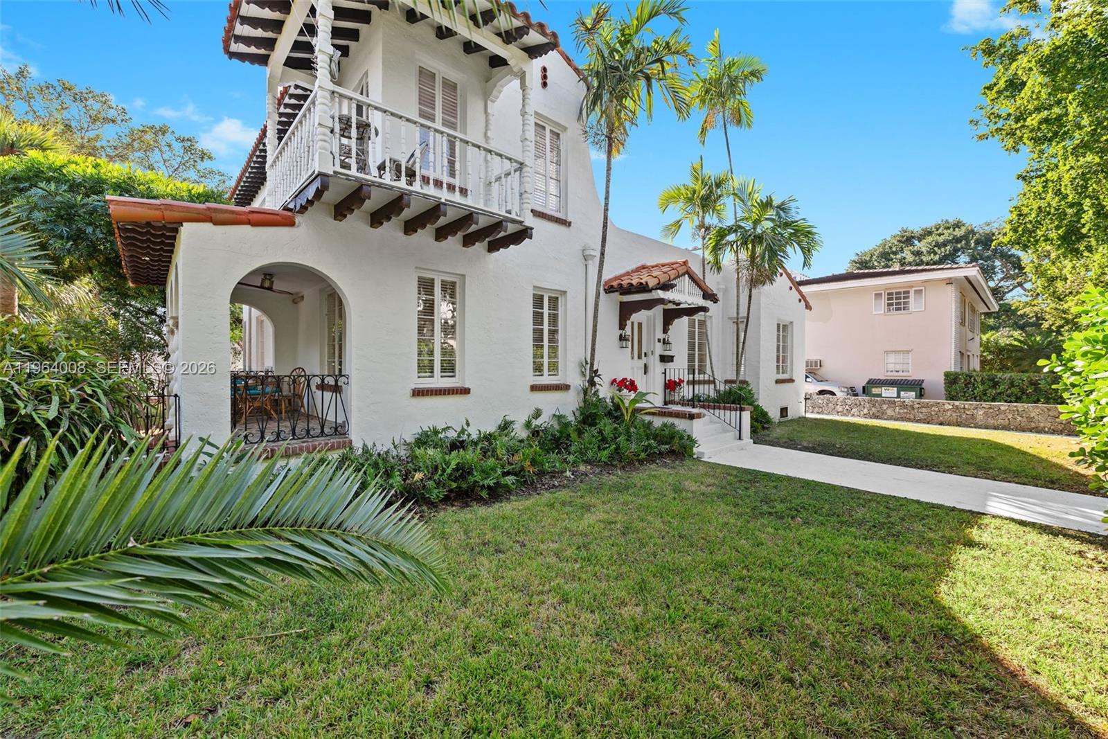 A two-story white stucco house with a balcony, arched porch, and red tile roof — 36 Phoenetia Ave, Coral Gables FL 33134, CORAL GABLES, FL