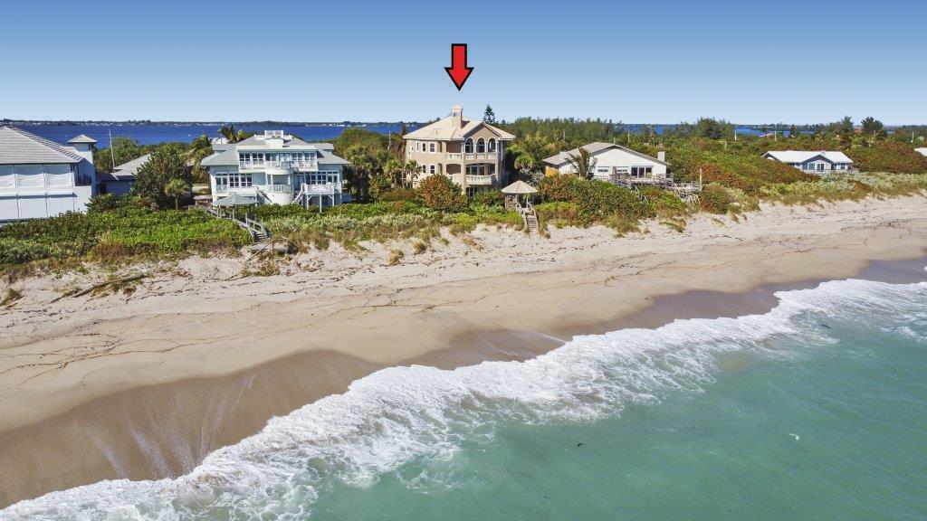 An aerial view of a multi-story house on a sandy beach by the ocean — 8327 S Hwy A1a, Melbourne Beach FL 32951, MELBOURNE BEACH, FL