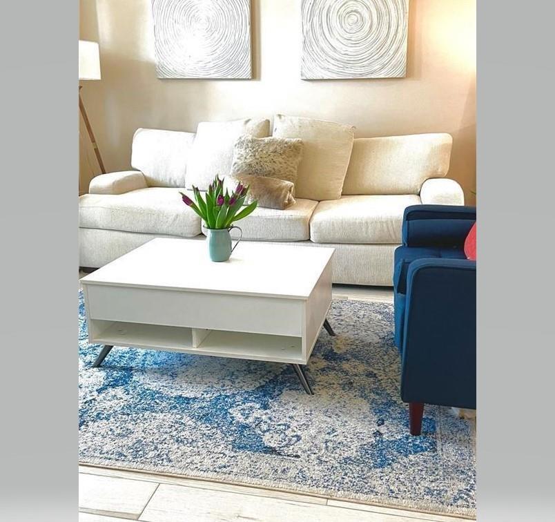 A living room features a cream sofa, a white coffee table, and a blue rug — 275 Murcia Drive # 308, Jupiter FL 33458, JUPITER, FL