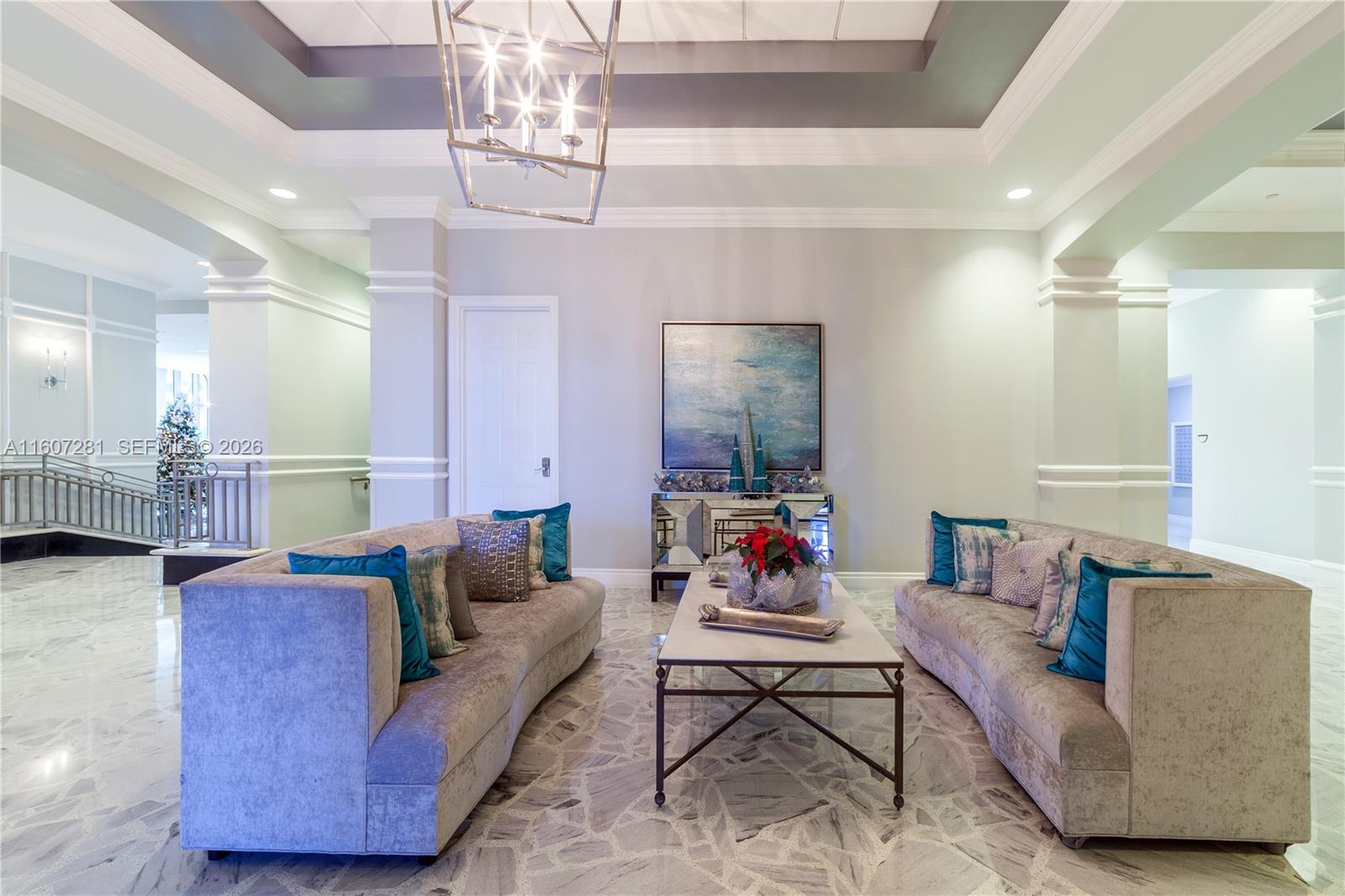 A formal lobby features two curved sofas, a central coffee table, and marble flooring — 2501 S Ocean Dr # 303, Hollywood FL 33019, HOLLYWOOD, FL
