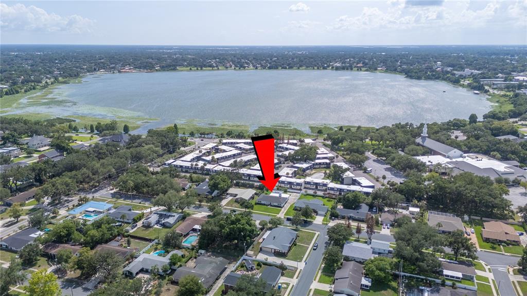 An aerial view shows a residential neighborhood with a lake in the background — 1211 HUNT AVENUE, LAKELAND, FL