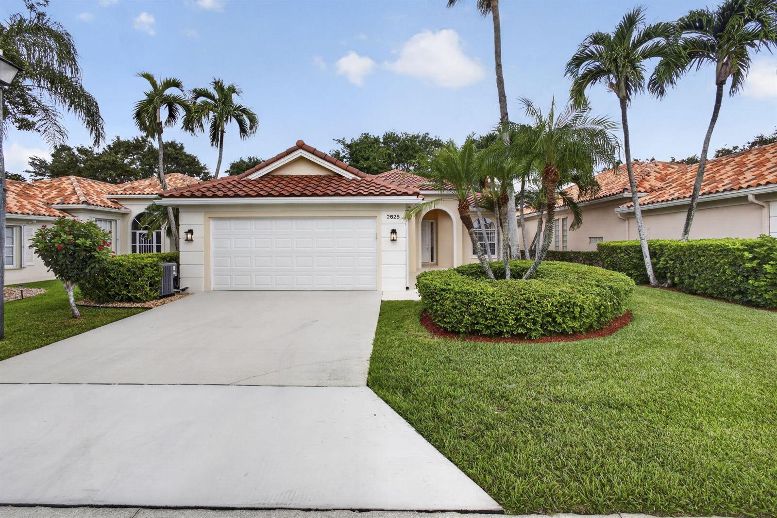 A single-story house with a white garage, tile roof, and palm trees in the yard — 2625 Kittbuck Way, West Palm Beach FL 33411, WEST PALM BEACH, FL