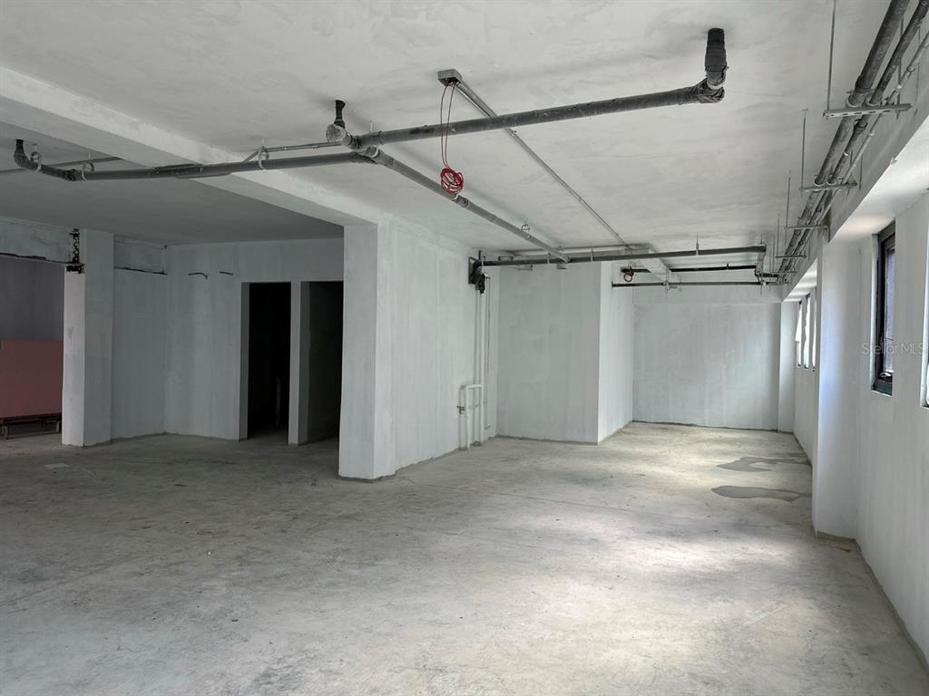 An unfinished commercial space features exposed ceiling pipes, white walls, and concrete flooring — 656 RH TODD UNIT 1, SAN JUAN, PR