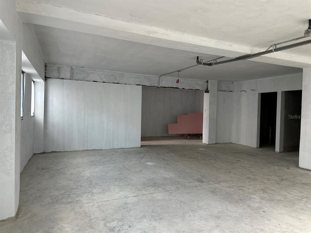 An unfinished interior space features concrete floors, white walls, and exposed ceiling pipes — 656 RH TODD UNIT 1, SAN JUAN, PR