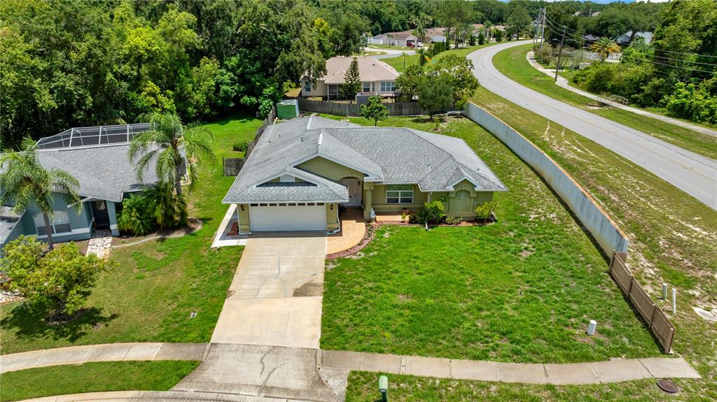 An aerial view of a single-story house with a gray roof and a concrete driveway — 5146 WORTH COURT, NEW PORT RICHEY, FL