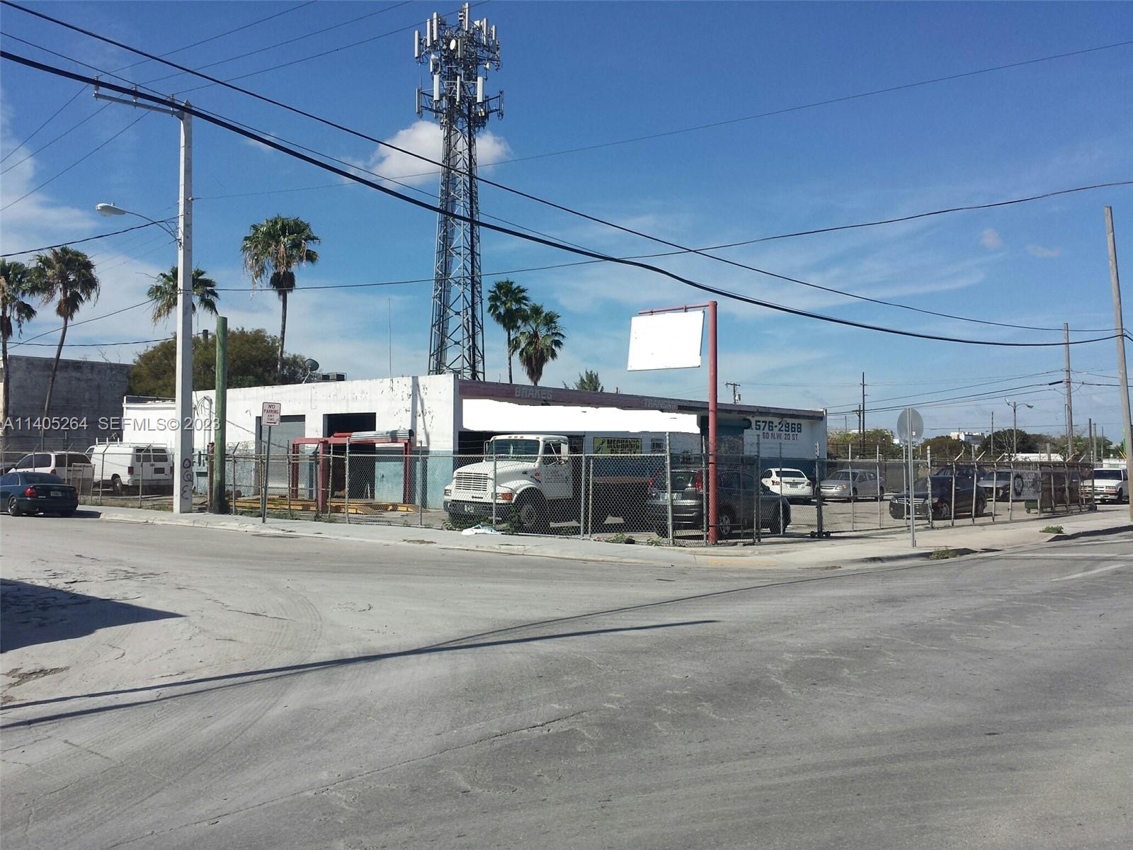 An auto repair shop with a fenced lot and a large communication tower behind it — 60 NW 20th St, Miami FL 33127, MIAMI, FL