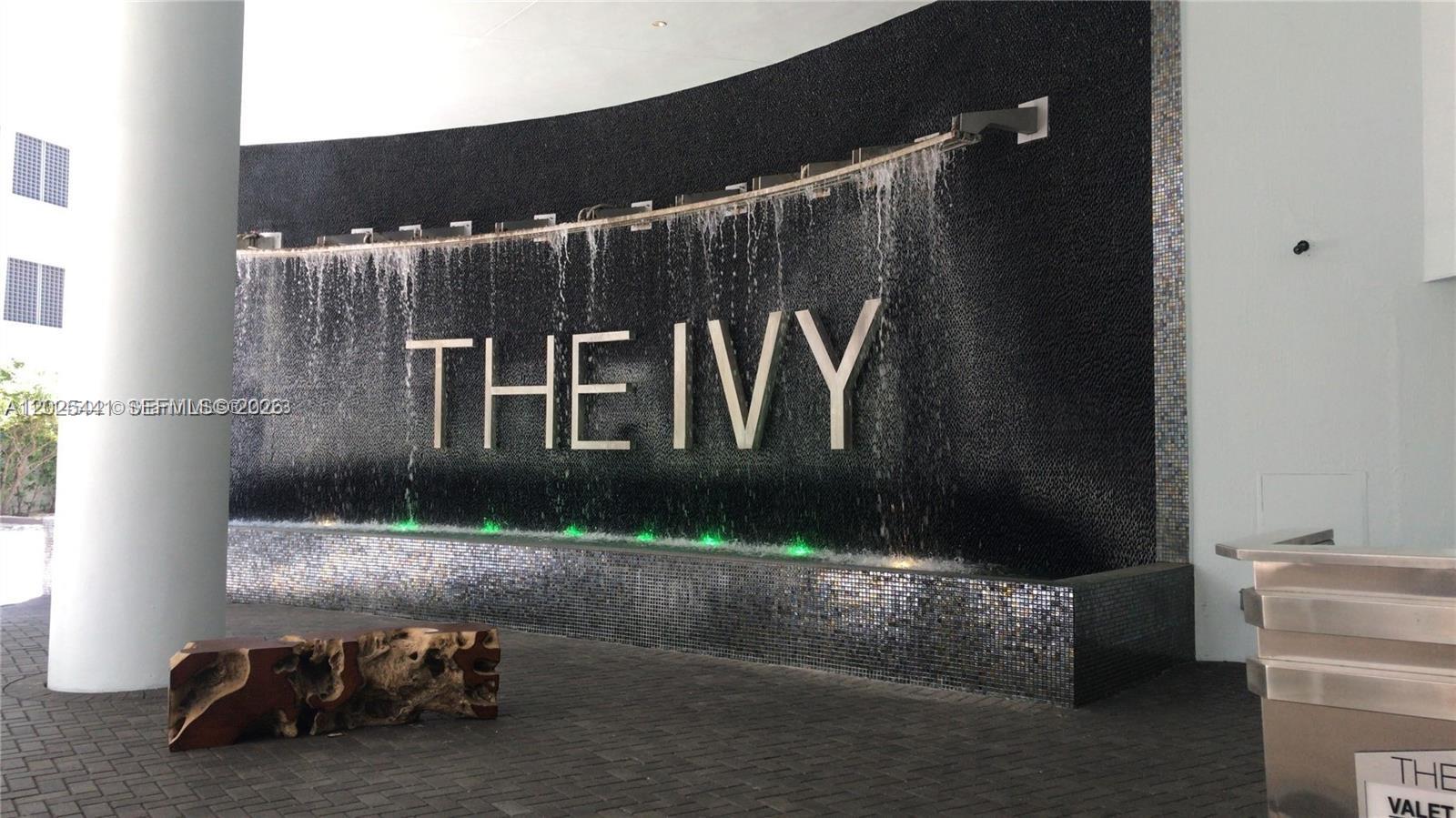 A curved wall features a water fountain with the text THE IVY in large letters — 90 SW 3rd St # 3708, Miami FL 33130, MIAMI, FL