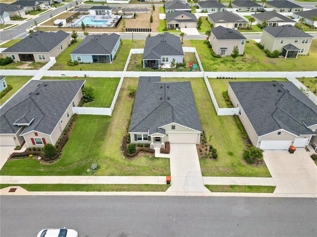 An aerial view shows a suburban neighborhood with several single-family homes and a community pool — 9324 SW 58TH CIRCLE, OCALA, FL