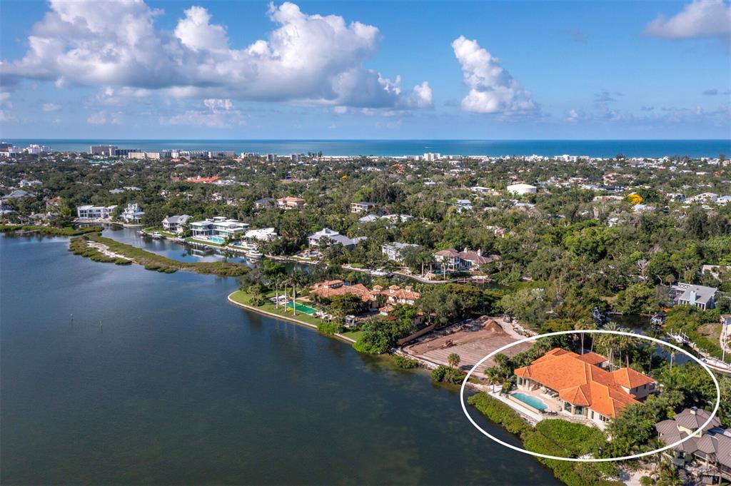 An aerial view shows a waterfront house with a red-tiled roof and a swimming pool — 1280 HIDDEN HARBOR WAY, SARASOTA, FL