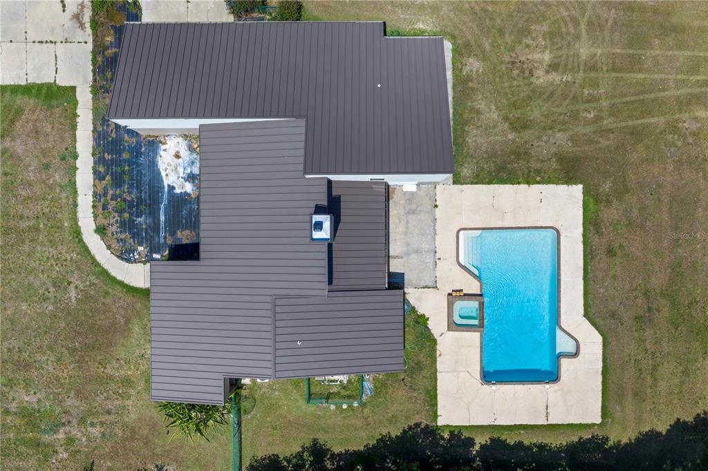 An aerial view shows a house with a pool on a large, tree-filled residential lot — 3261 SE 41ST PLACE, OCALA, FL