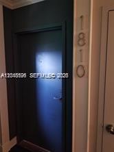 A dark-painted door features the number 1810 mounted vertically on the adjacent light-colored wall — 780 NE 69th St # 1810, Miami FL 33138, MIAMI, FL