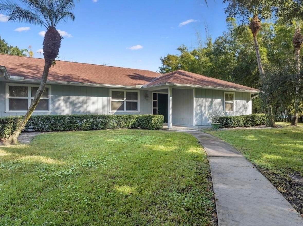 A single-story house with light gray siding, a brown roof, and a concrete walkway — 4790 16th Street, Vero Beach FL 32966, VERO BEACH, FL