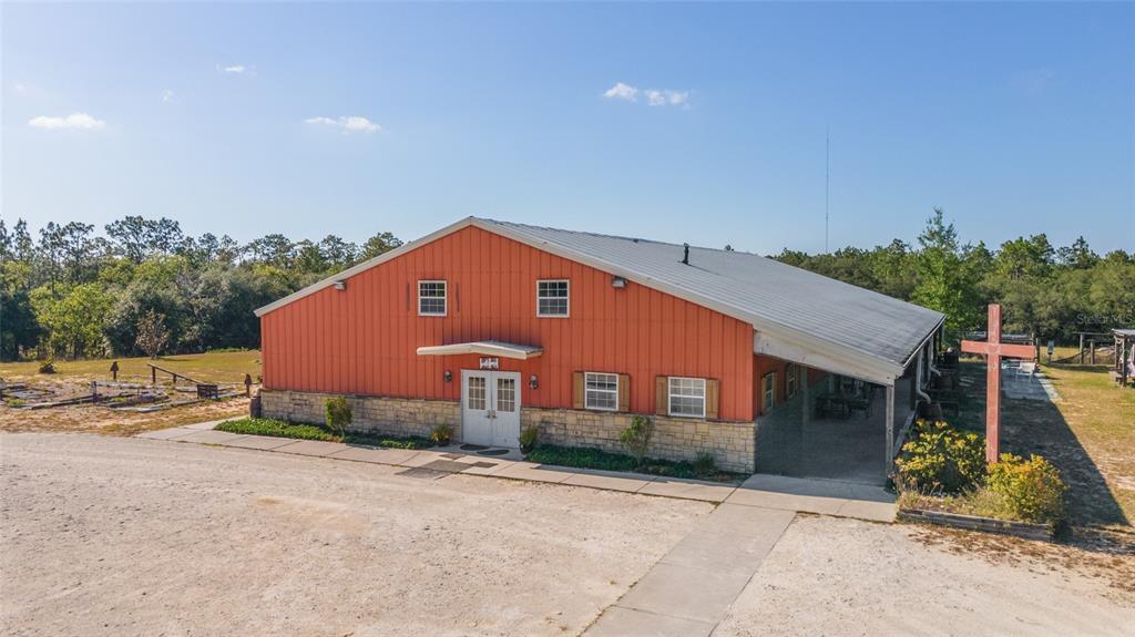 An exterior view of a metal-sided building with a stone base and a cross — 6491 & 6481 SE 123RD TERRACE, MORRISTON, FL