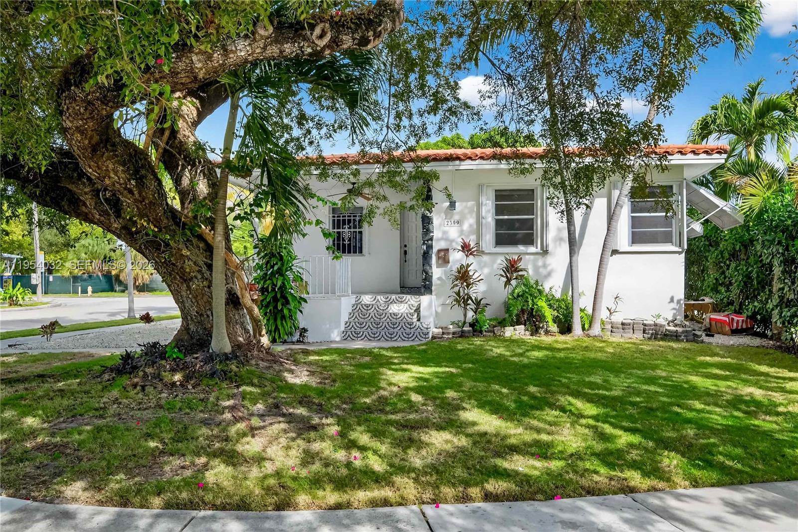 A white single-story house with a red tile roof and patterned front steps — 2399 SW 26th Ln, Miami FL 33133, MIAMI, FL