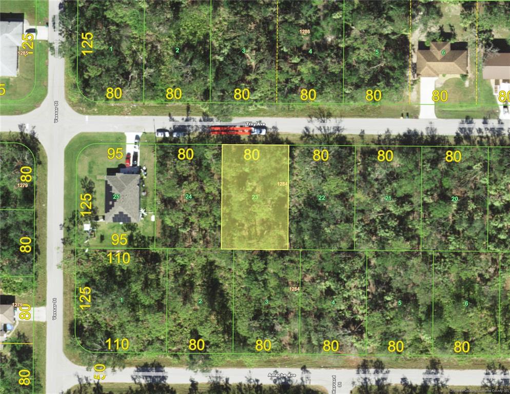 This is a satellite map showing a highlighted rectangular plot of land between two streets — 23153 TROY AVENUE, PUNTA GORDA, FL