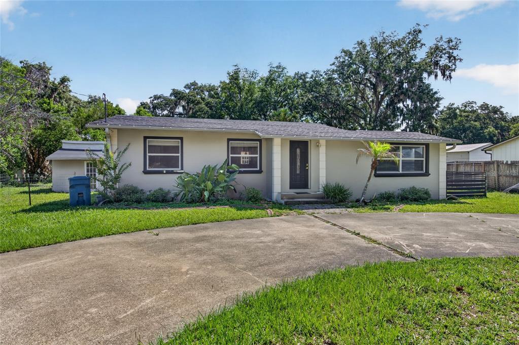 A single-story house with a concrete driveway, light-colored siding, and dark-framed windows — 1145 GEORGE ANDERSON STREET, ORMOND BEACH, FL
