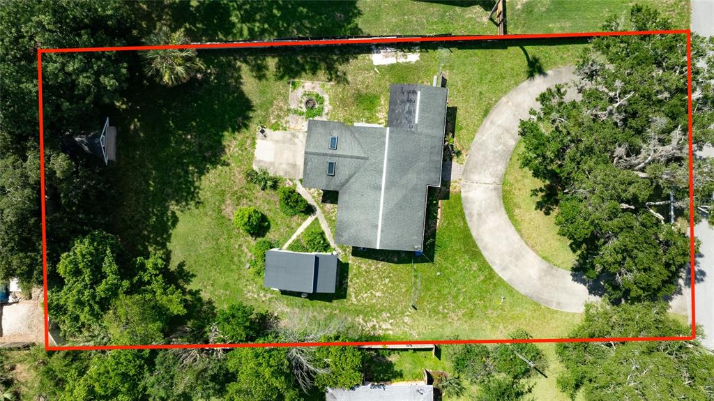 An aerial view shows a house with a circular driveway on a tree-lined lot — 1145 GEORGE ANDERSON STREET, ORMOND BEACH, FL