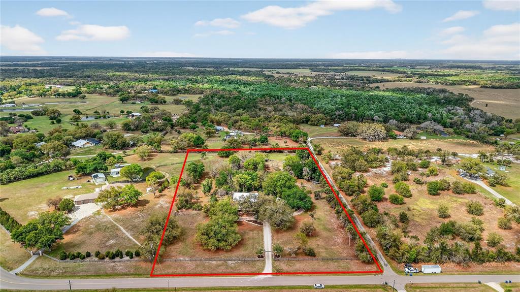 An aerial view shows a house on a large, fenced lot with trees and grass — 6888 MYAKKA VALLEY TRL, SARASOTA, FL