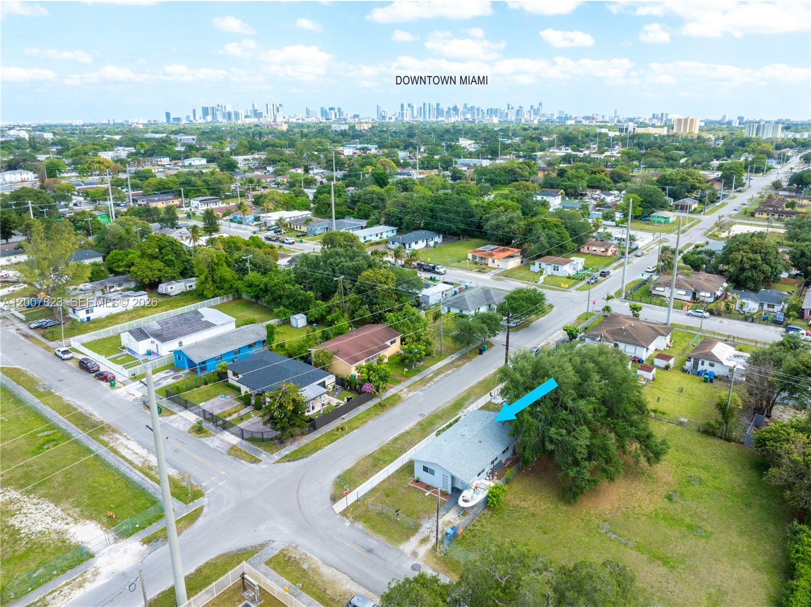 An aerial view shows a single-story house with a boat parked in the yard — 2406 NW 67th St, Miami FL 33147, MIAMI, FL