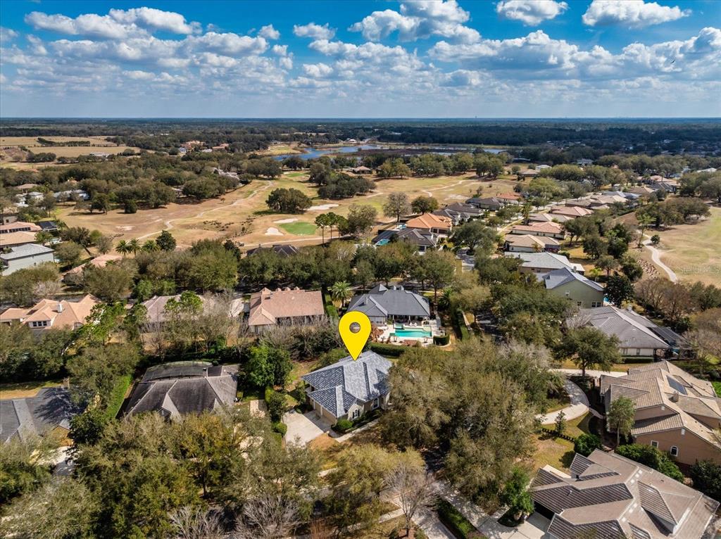 An aerial view shows a residential house with a gray roof and a yellow location pin — 25516 HAWKS RUN LANE, SORRENTO, FL