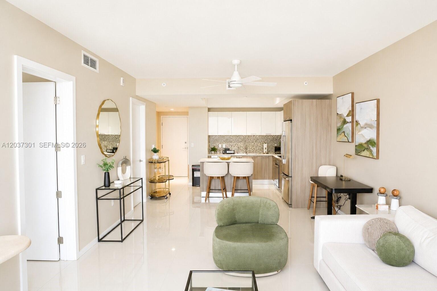 This open-concept living area features a kitchen with an island and a dining space — 5300 Paseo Blvd # 1510, Doral FL 33166, DORAL, FL