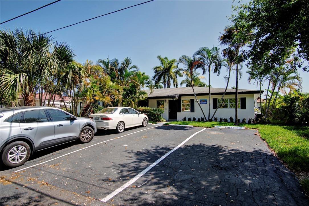 A single-story building with a paved parking lot and palm trees in front — 3860 NE 23rd Avenue, Lighthouse Point FL 33064, LIGHTHOUSE POINT, FL