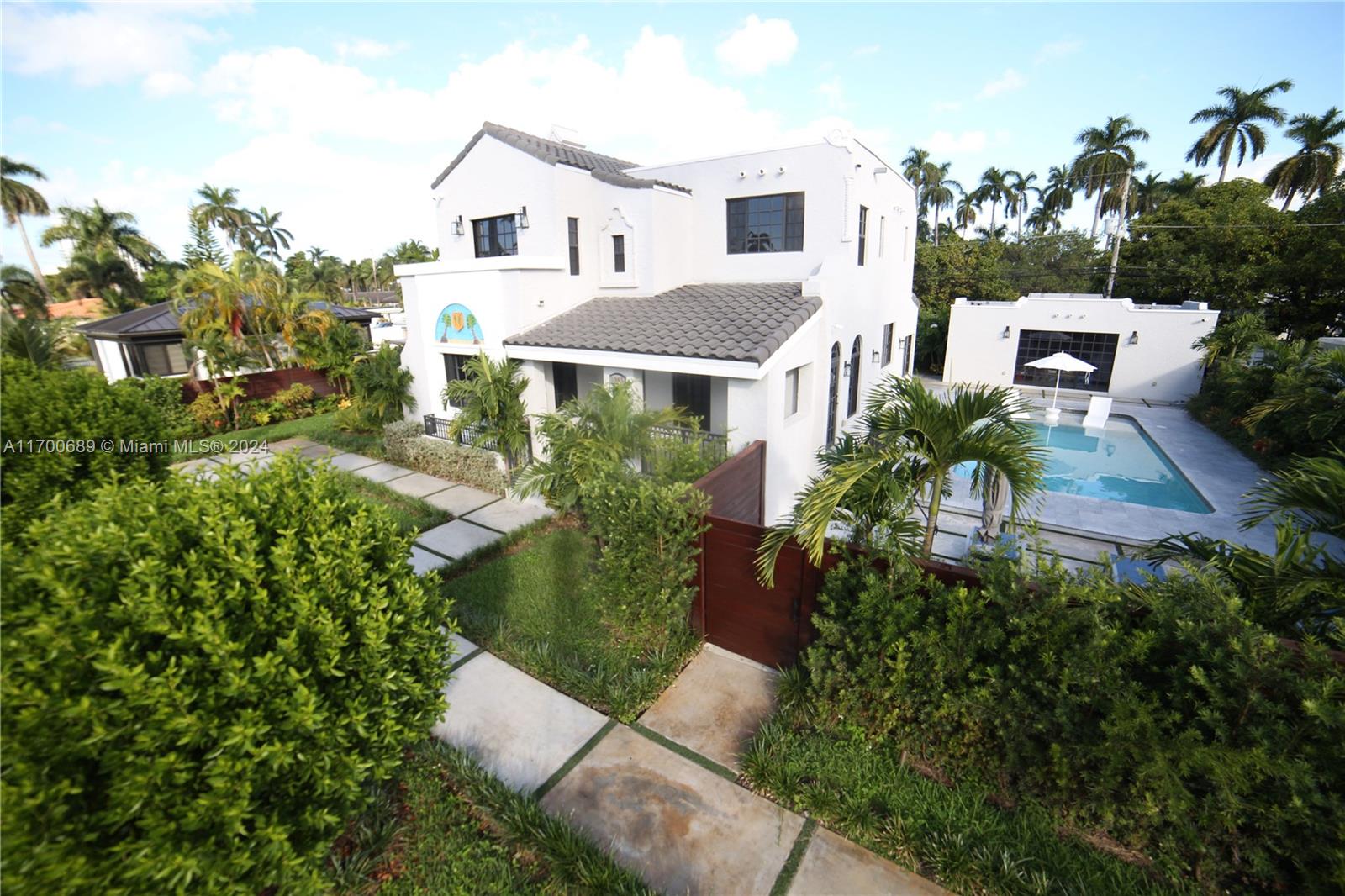 An aerial view shows a white two-story house with a pool and a detached garage — 1345 Hollywood Blvd, Hollywood FL 33019, HOLLYWOOD, FL