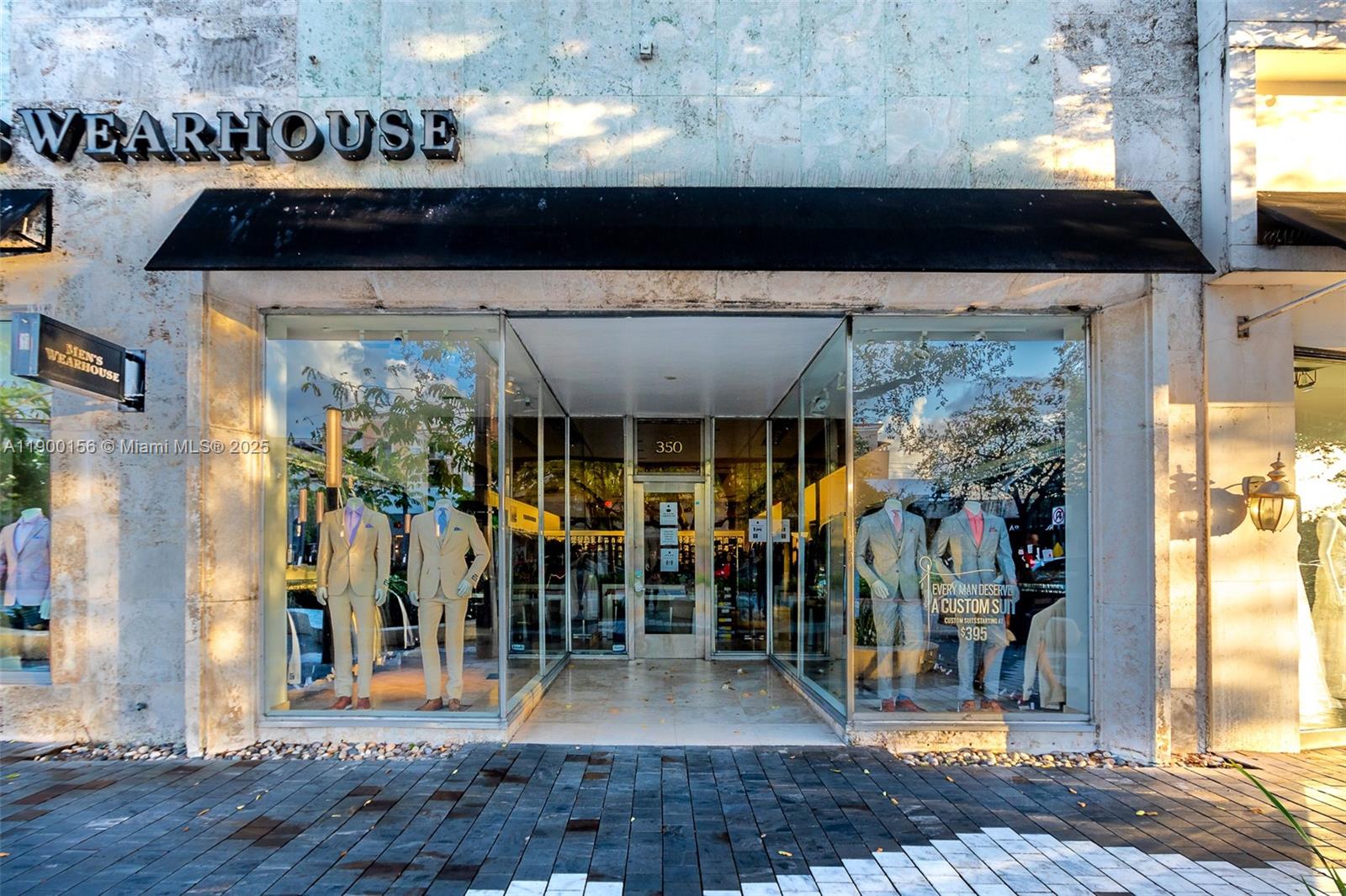 The exterior of a retail storefront features large glass display windows and a black awning — 350 Miracle Mile, Coral Gables FL 33134, CORAL GABLES, FL