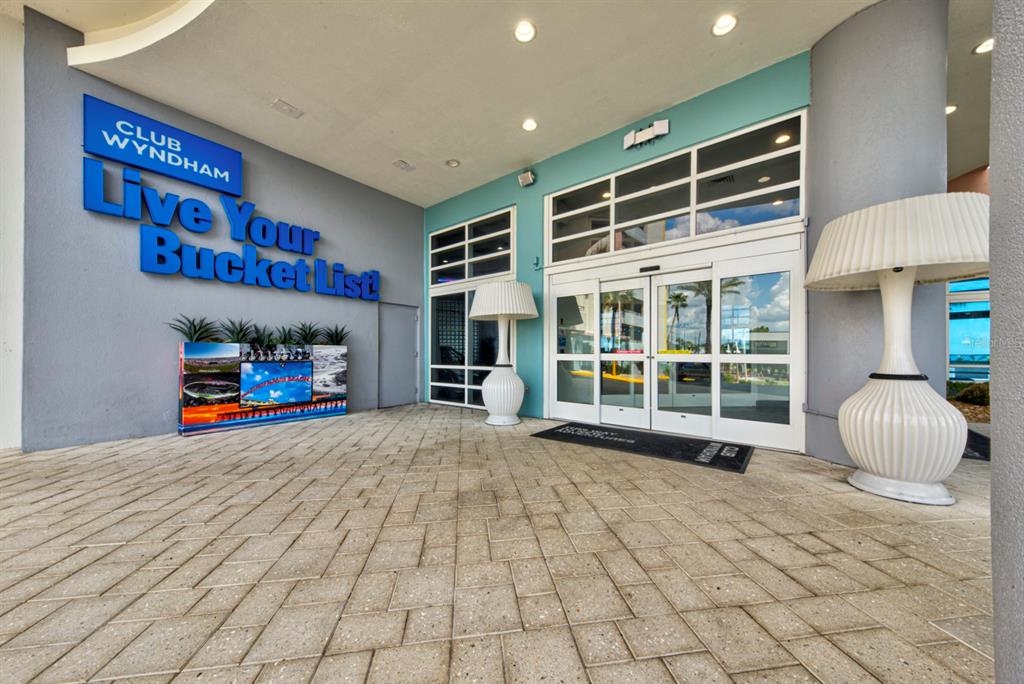 The exterior entrance of a Club Wyndham resort features a paved walkway and large lamps — 350 N ATLANTIC AVENUE UNIT 2328, DAYTONA BEACH, FL