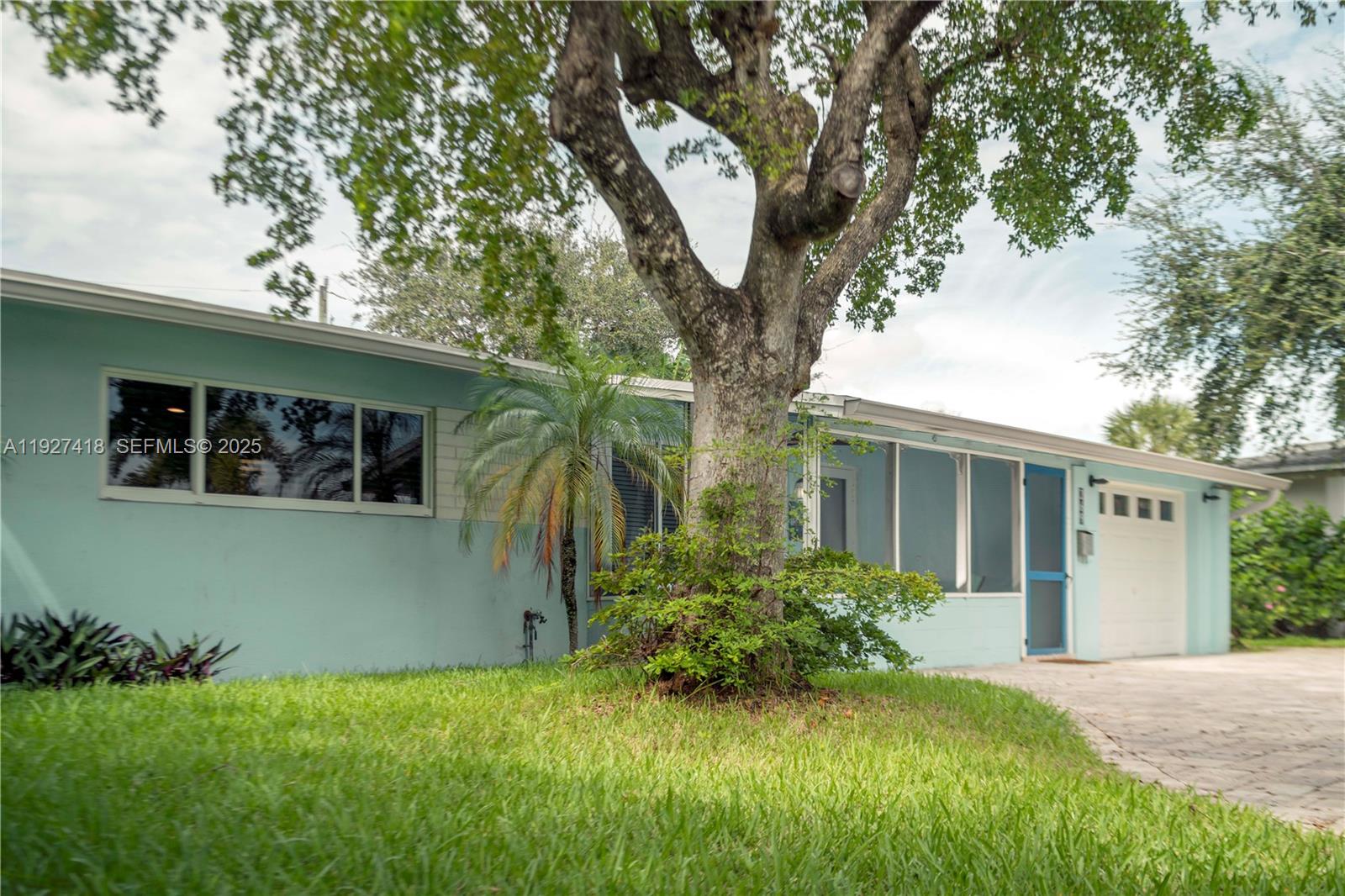 A light blue single-story house features a large tree in the front yard — 269 SE 8th Ave, Deerfield Beach FL 33441, DEERFIELD BEACH, FL