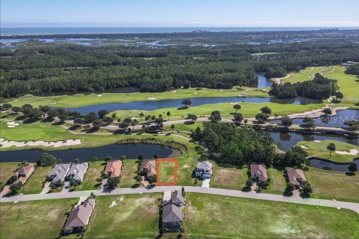 An aerial view shows a vacant residential lot outlined in orange within a golf course community — 339 HIBISCUS WAY, PALM COAST, FL