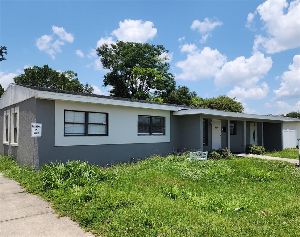 A single-story gray house with a white trim and a parking sign in the yard — 60 S SEMORAN BOULEVARD, ORLANDO, FL