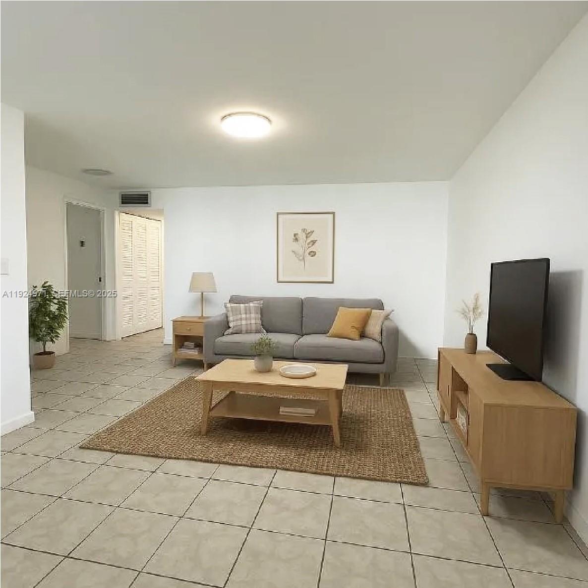 A living room features a gray sofa, wooden coffee table, media console, and tile flooring — 60 NW 161st St, Miami FL 33169, MIAMI, FL