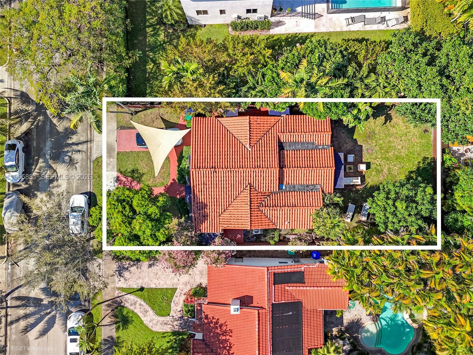 An aerial view shows a house with a red tile roof and a shade sail — 717 NE 73rd St, Miami FL 33138, MIAMI, FL
