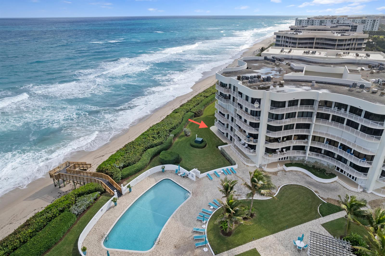 An aerial view shows a beachfront condominium building with a pool and a grassy lawn — 3360 S Ocean Boulevard, Palm Beach FL 33480, PALM BEACH, FL