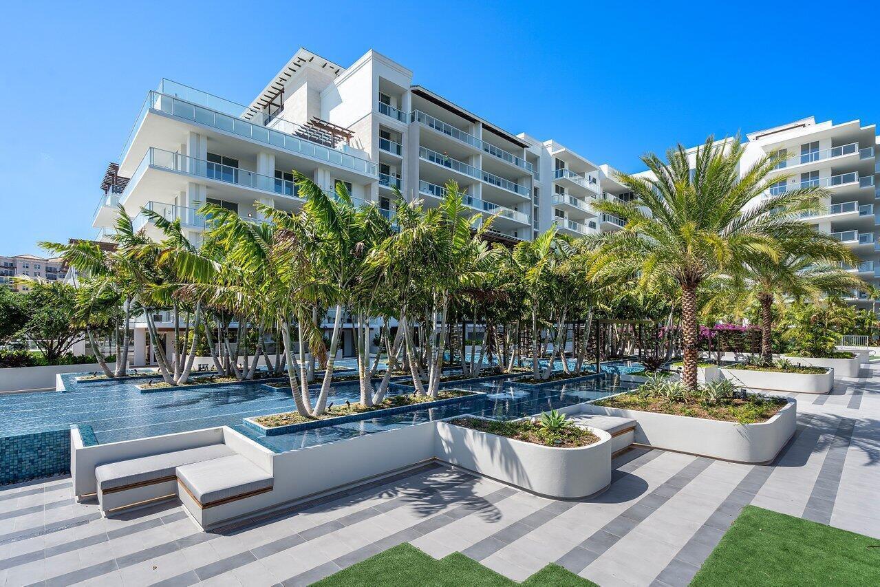 A bright entryway leads through double doors into a living area with large windows — 210 SE Mizner Boulevard # 301, Boca Raton FL 33432, BOCA RATON, FL