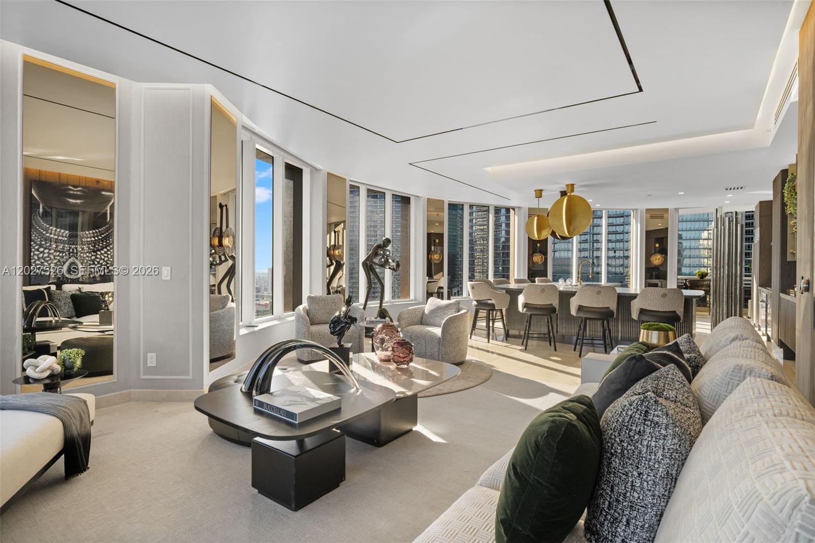 A modern living room features a coffee table, armchairs, a sofa, and a kitchen island — 901 Brickell Key Blvd # 3304, Miami FL 33131, MIAMI, FL