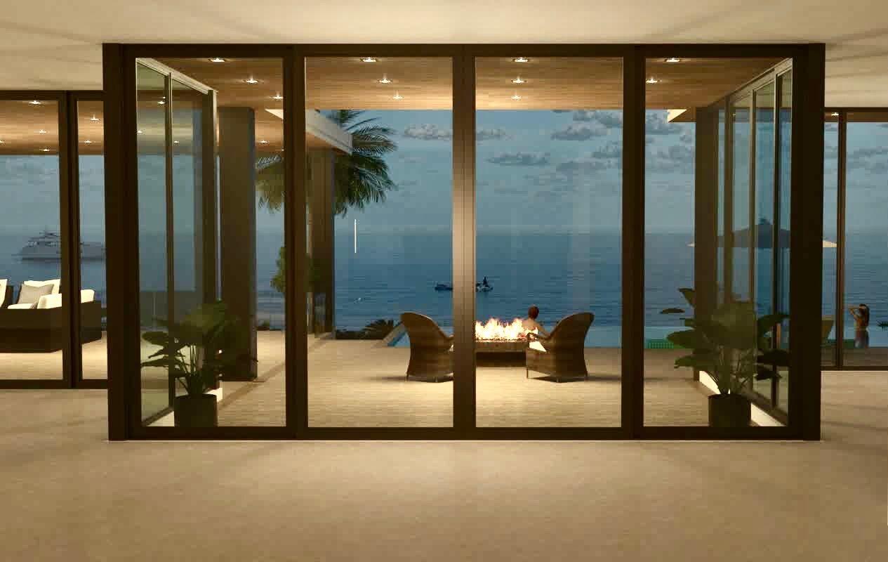 This rendering shows a modern interior looking through large glass doors toward an oceanfront patio — 3060 S Ocean Boulevard, Manalapan FL 33462, MANALAPAN, FL