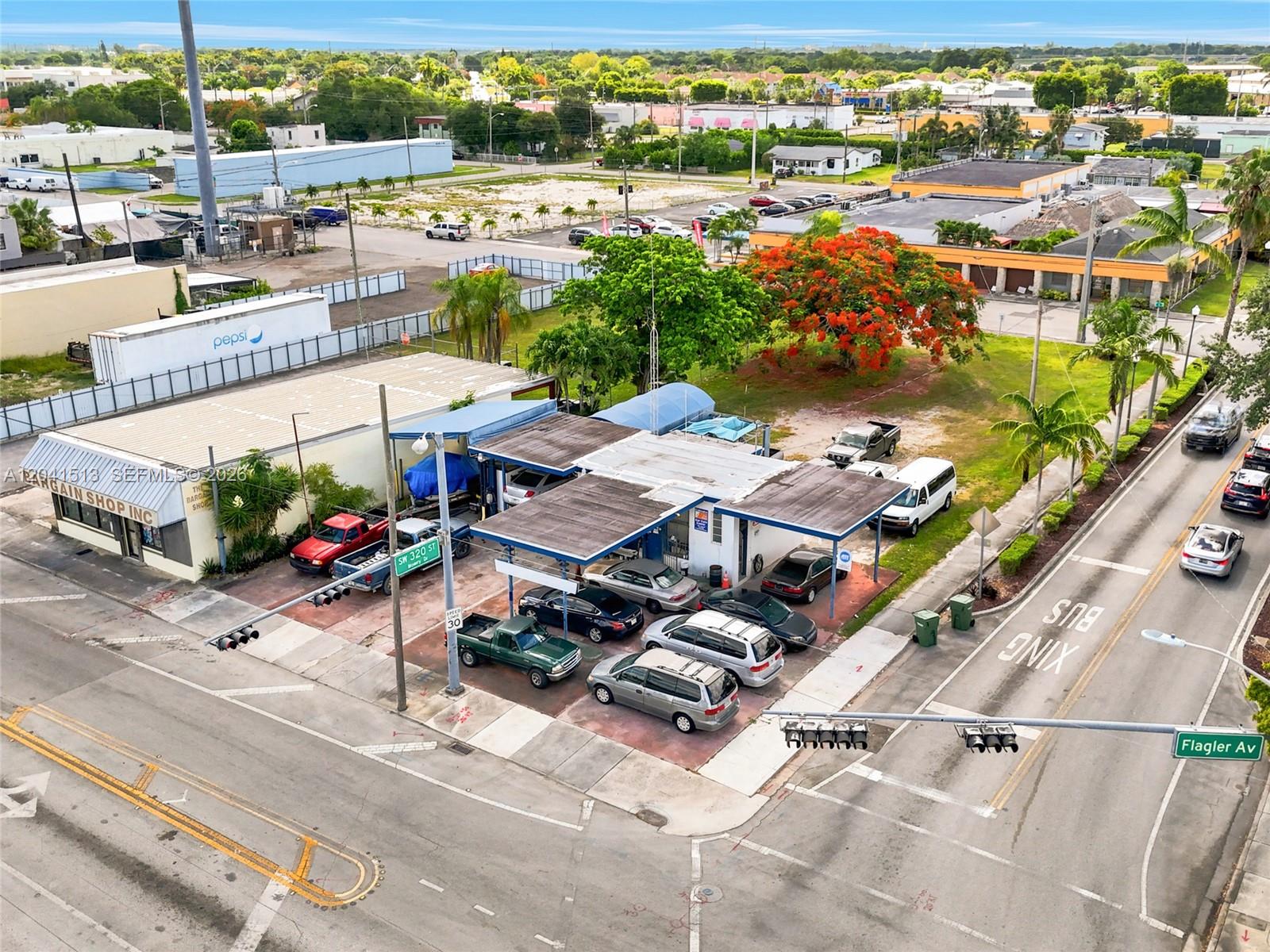 An aerial view shows a commercial auto repair shop with multiple parked cars and bays — 3 N Flagler Ave, Homestead FL 33030, HOMESTEAD, FL