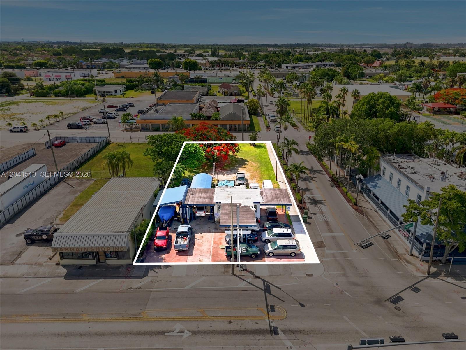 An aerial view highlights a commercial auto repair property with a parking lot and building — 3 N Flagler Ave, Homestead FL 33030, HOMESTEAD, FL