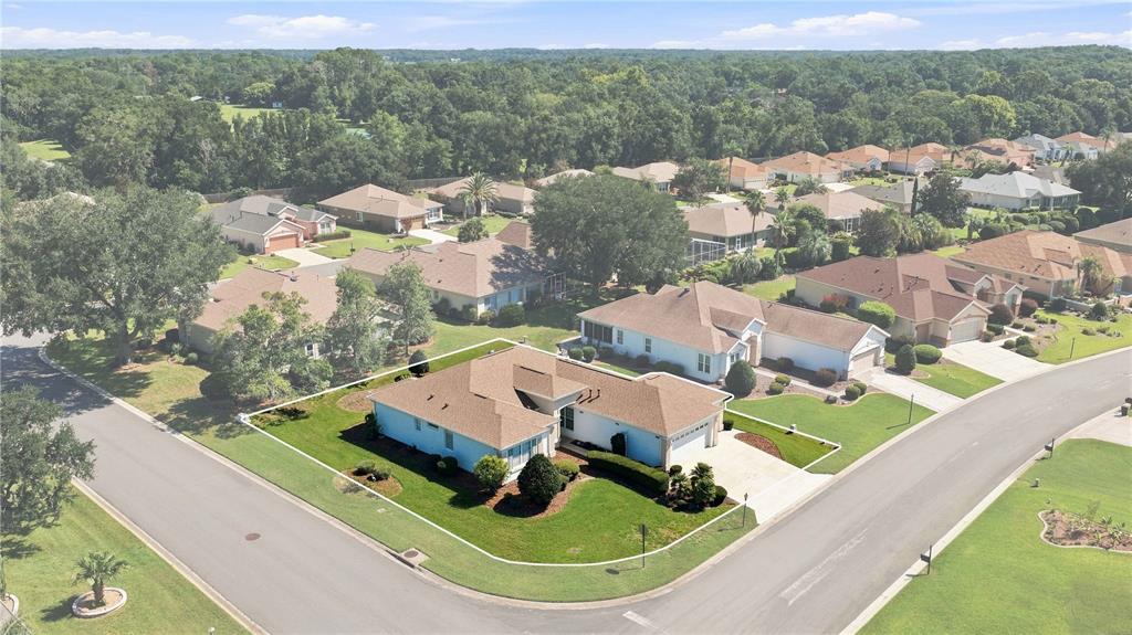 An aerial view shows a single-story house with a brown roof on a corner lot — 9317 124TH PLACE, SUMMERFIELD, FL