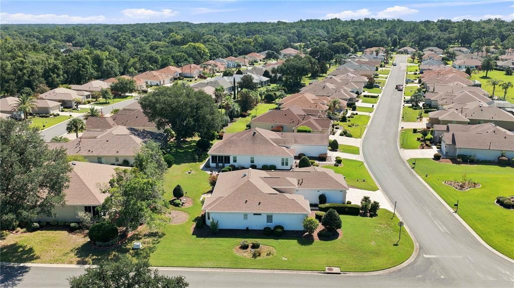 An aerial view of a suburban neighborhood featuring single-family homes with tan roofs and lawns — 9317 124TH PLACE, SUMMERFIELD, FL