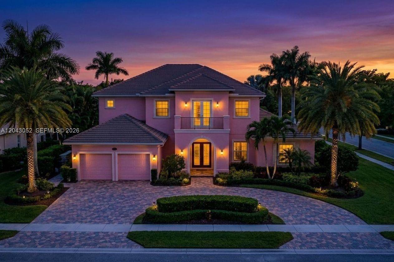 A two-story pink house with a paved circular driveway and palm trees at sunset — 9316 Pearch Ln, Boynton Beach FL 33437, BOYNTON BEACH, FL