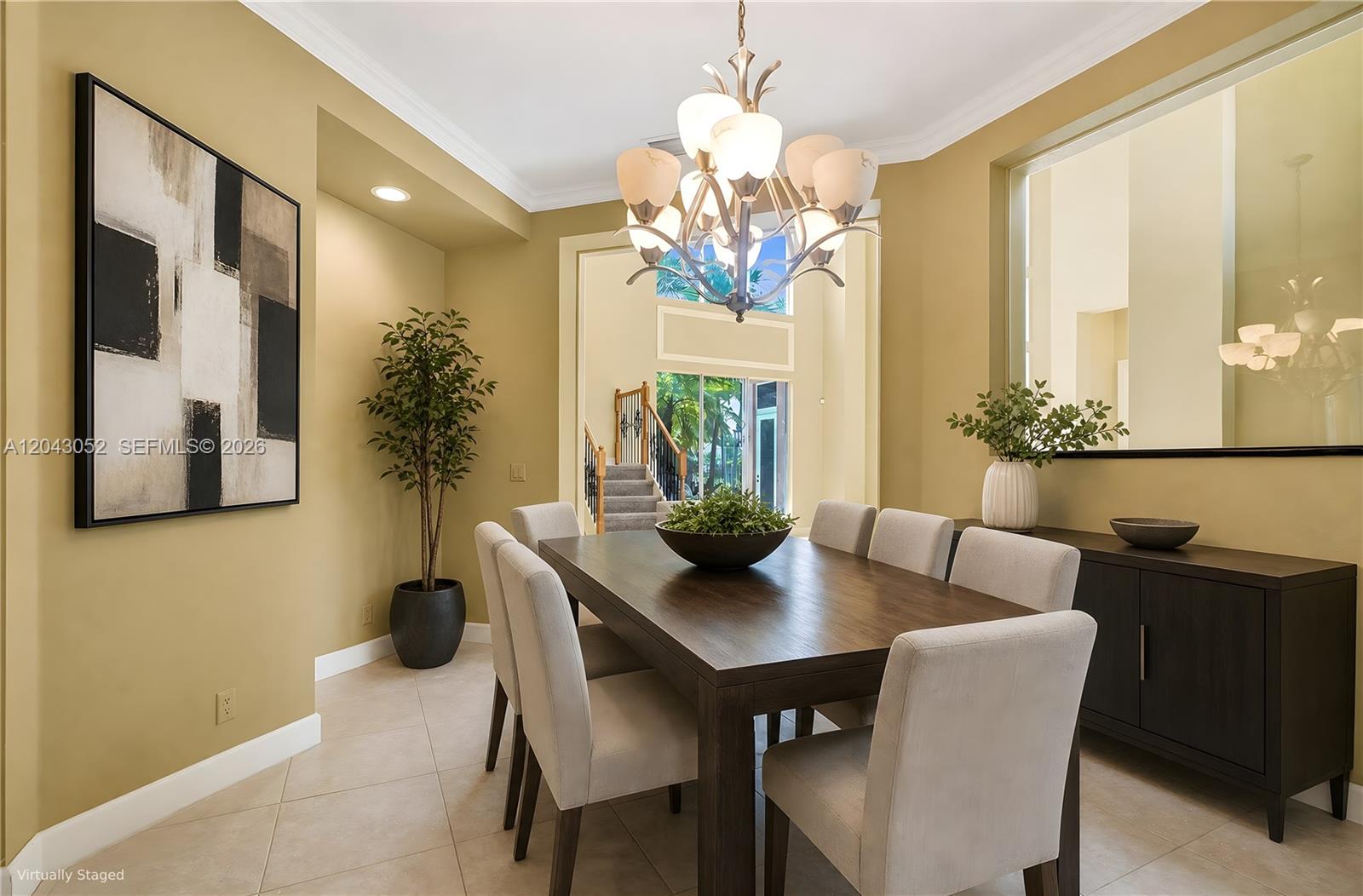 A dining room features a dark wood table, upholstered chairs, a chandelier, and a large mirror — 9316 Pearch Ln, Boynton Beach FL 33437, BOYNTON BEACH, FL