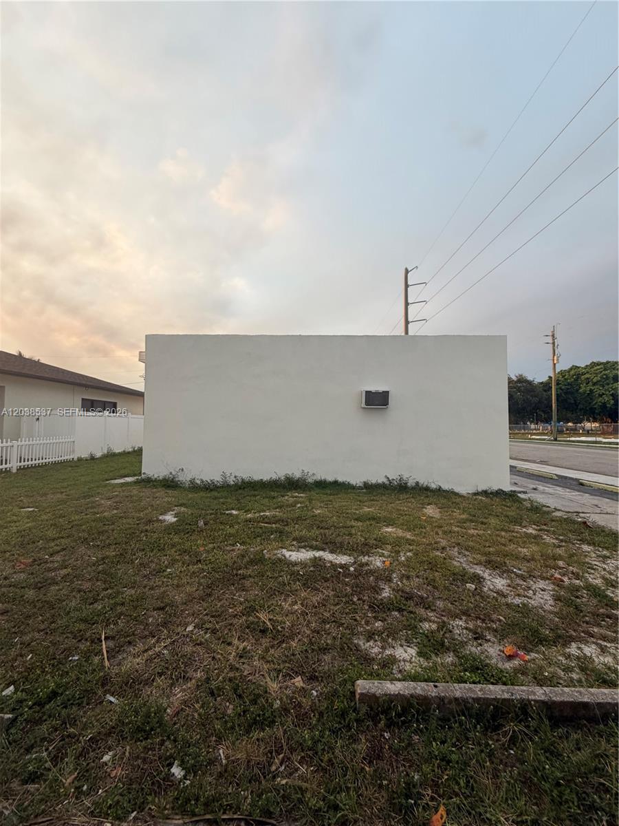 A plain, windowless exterior wall of a building stands on a grassy lot — 2910 N 22nd Ave, Hollywood FL 33020, HOLLYWOOD, FL