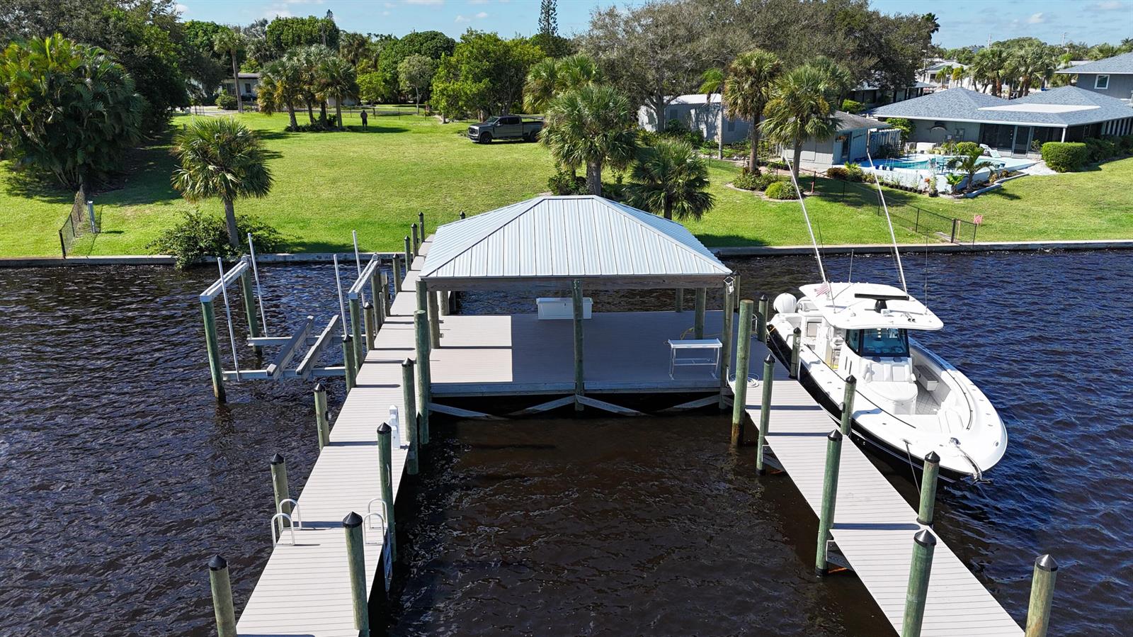 An aerial view of a boat dock with a covered slip and a docked boat — 4345 SE Mulford Lane, Stuart FL 34997, STUART, FL